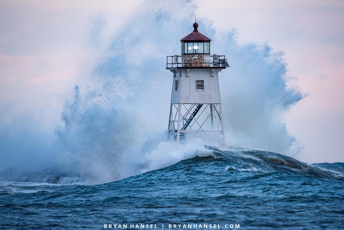 Waves wash against the Grand Marais, MN Lighthouse.