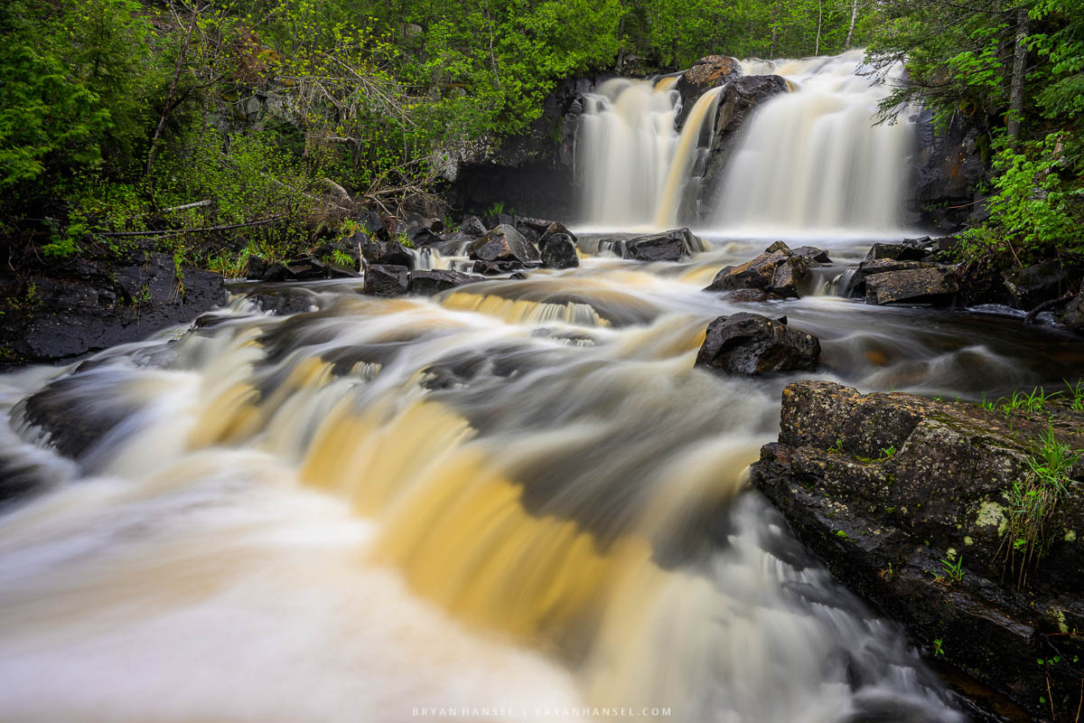 A waterfall in northern Minnesota that shows two drops. The small drop is next to the photographer's camera.